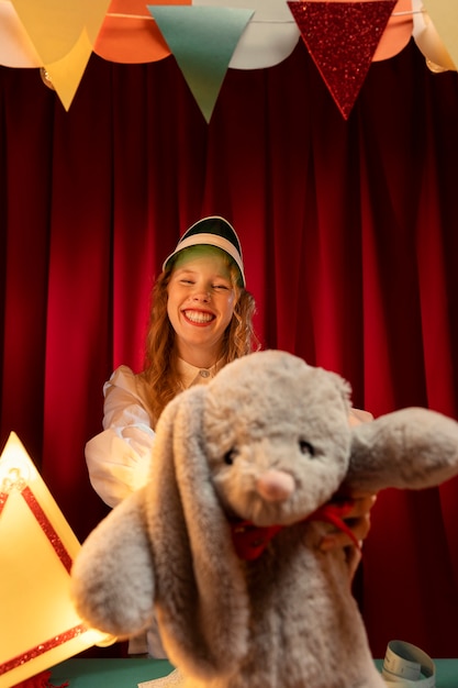 Free photo front view smiley woman holding  toy