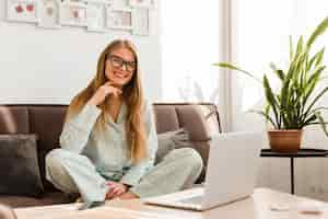 Free photo front view of smiley woman in pajamas working at home