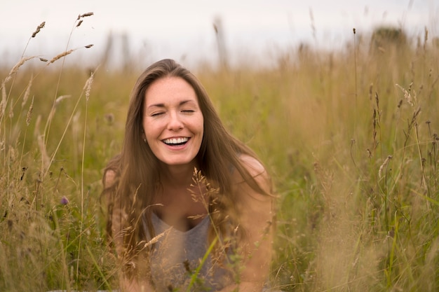 Free Photo front view smiley woman posing in nature