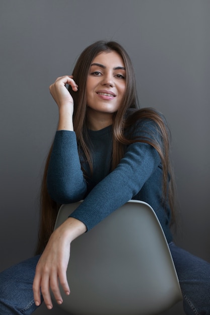 Front view smiley woman sitting on chair