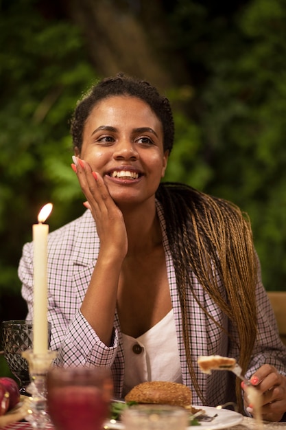 Front view smiley woman sitting at table