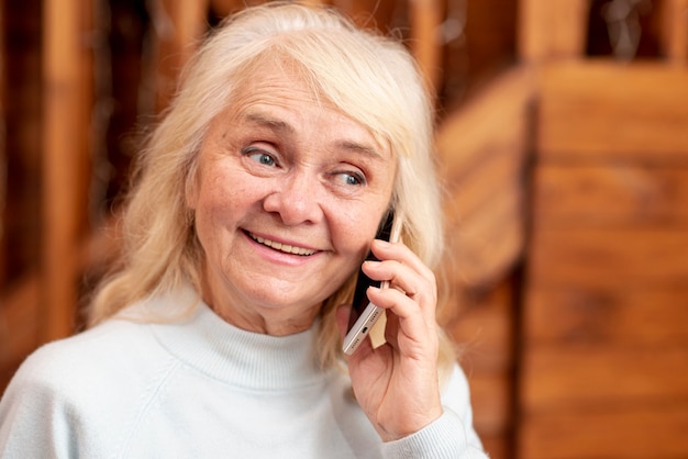 Front view smiley woman talking over phone