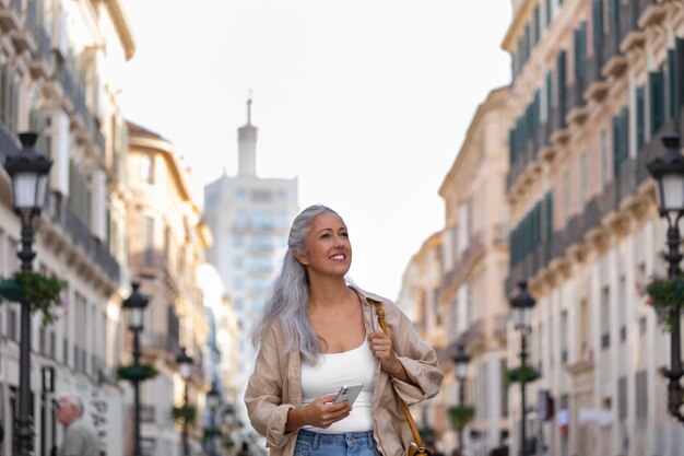 Front view smiley woman walking in city