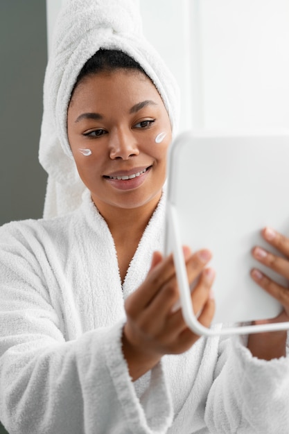 Front view smiley woman wearing bathrobe