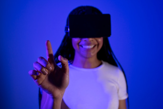 Front view smiley woman wearing vr glasses