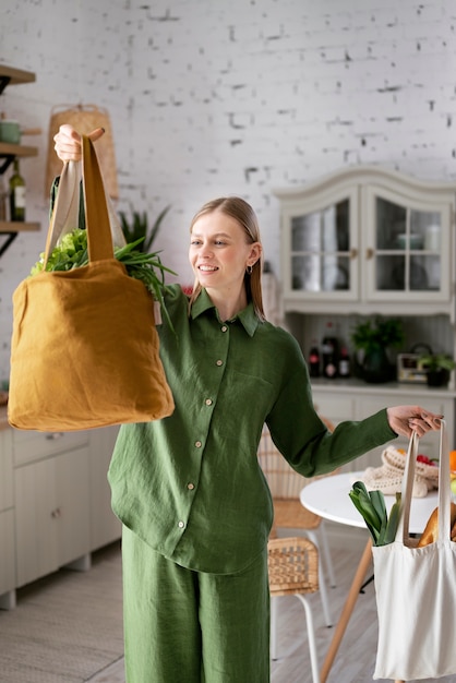 Free photo front view smiley woman with bags