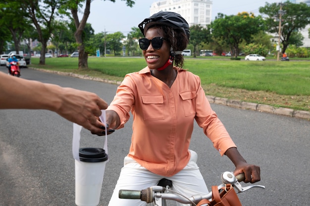 Front view smiley woman with bicycle