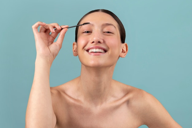 Front view smiley woman with  brow brush