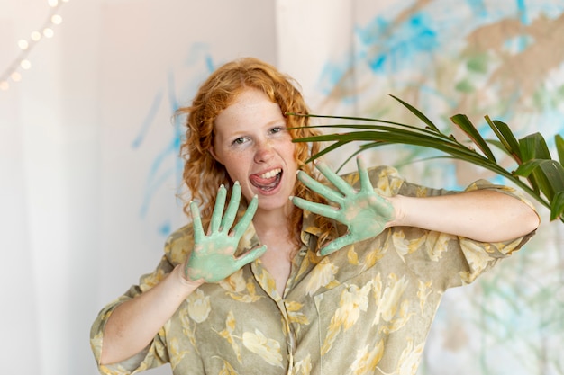 Free Photo front view smiley woman with paint on palms