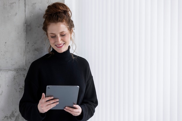 Front view smiley woman with tablet