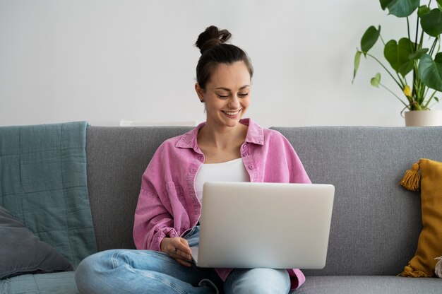 Front view smiley woman working on laptop