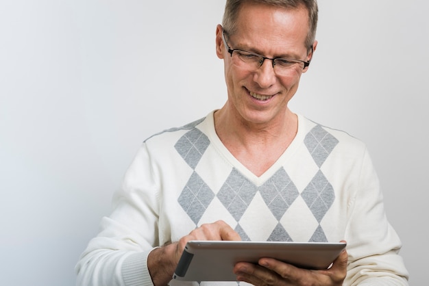 Front view of smiling father looking in tablet