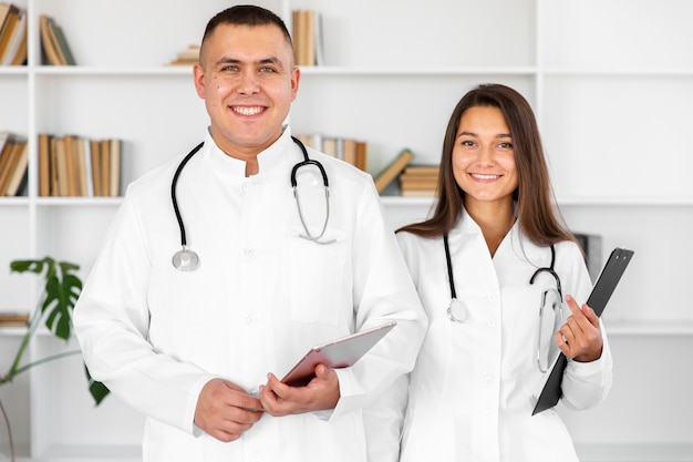 Front view smiling male and female doctor