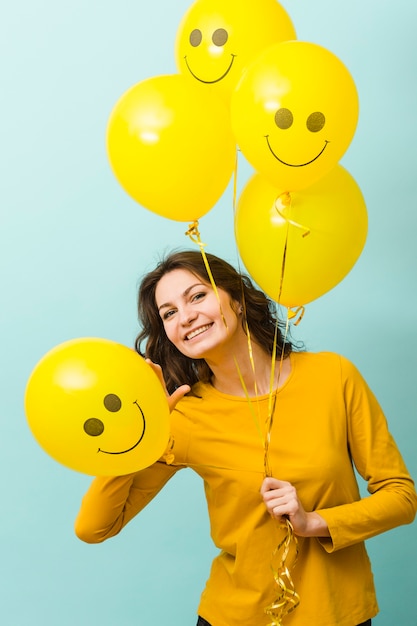 Free photo front view of smiling woman with balloons