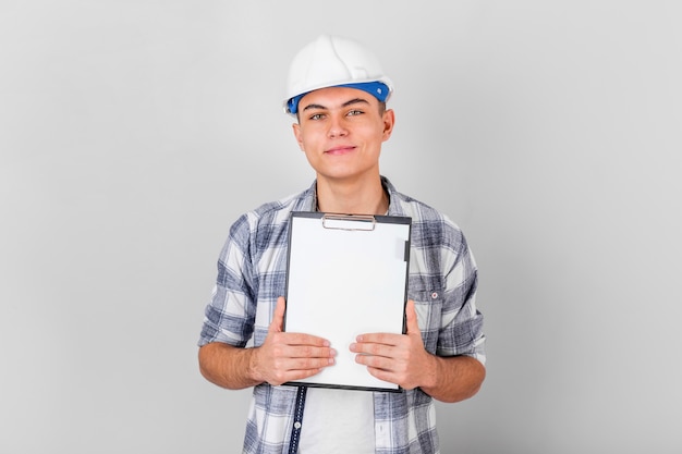 Front view of smiling young man holding a clipboard