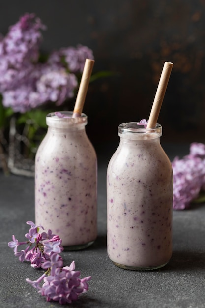 Free photo front view smoothie in bottles with hyacinth