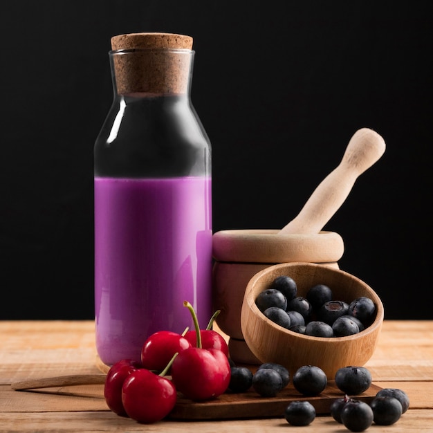 Free photo front view smoothie with cherries and blueberries