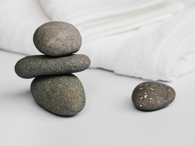 Free Photo front view spa stones next to towels