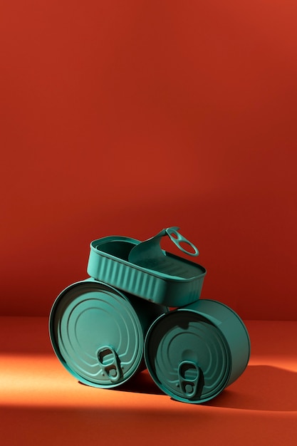 Free Photo front view stack of blue tin cans with copy-space