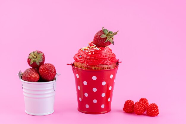 A front view strawberry cake inside little basket along with fresh red strawberries on pink desk