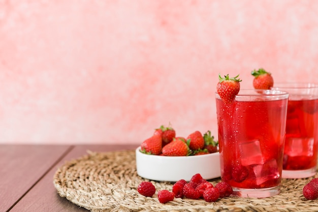 Front view of strawberry cocktails and fruits