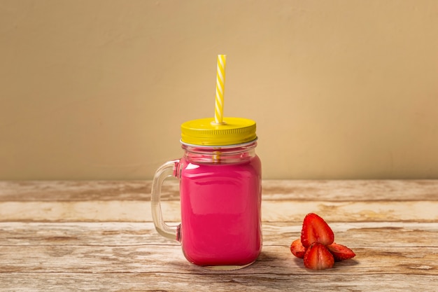 Front view strawberry smoothie on table