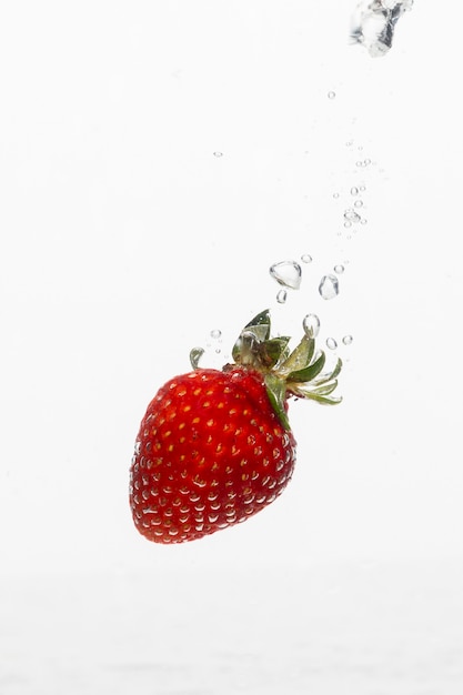 Free photo front view of strawberry in water with copy space