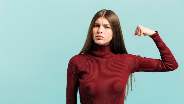 Free photo front view strong woman in studio