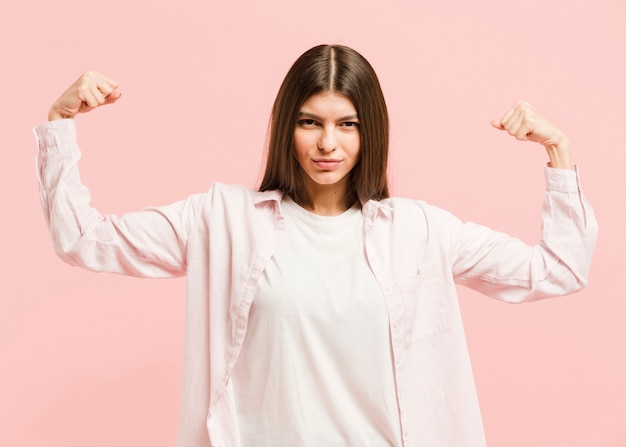 Free photo front view strong woman in studio