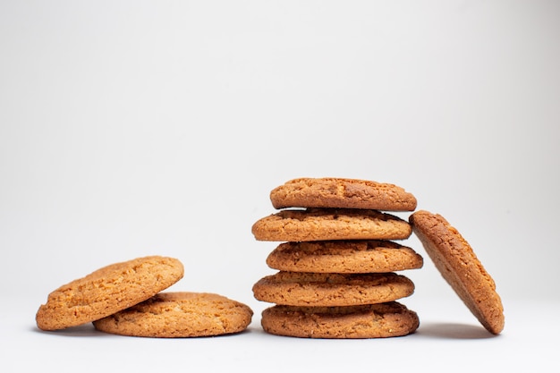 Free photo front view sweet biscuits on white desk cookies sugar dessert tea photo cake