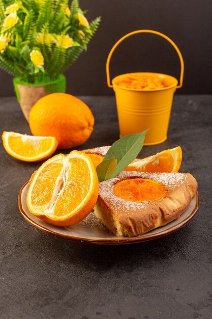 A front view sweet orange cake sweet delicious slices of cake along with sliced orange inside round plate on the grey background biscuit sweet sugar