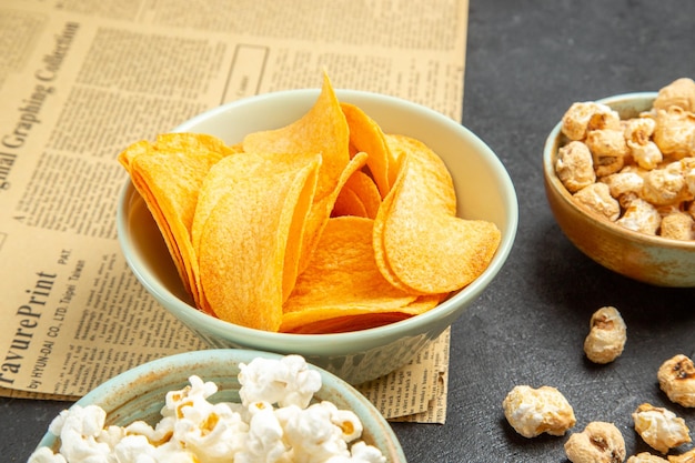 Front view tasty cheese cips with different snacks on a dark background