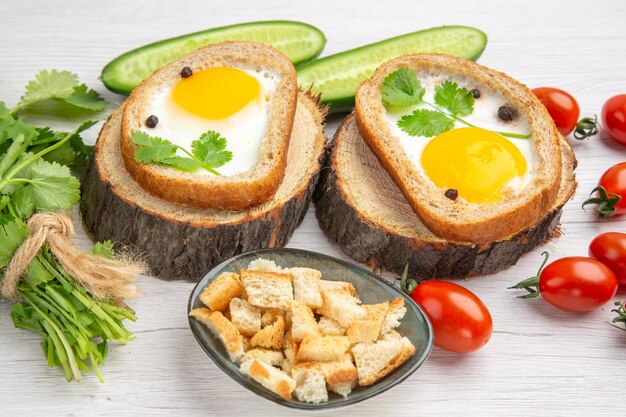 Front view tasty egg toasts with greens and vegetables on white background lunch ripe food breakfast salad diet healthy life meal