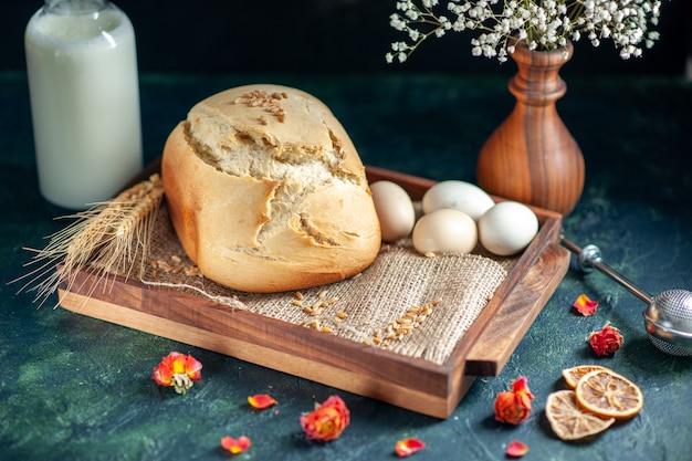 Free Photo front view tasty fresh bread with eggs and milk on dark surface