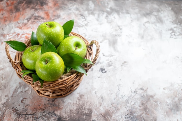 Front view tasty green apples inside basket on light background