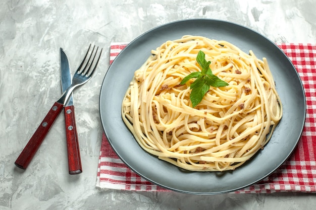 Front view tasty italian pasta with cutlery on white meal dough photo color dish food