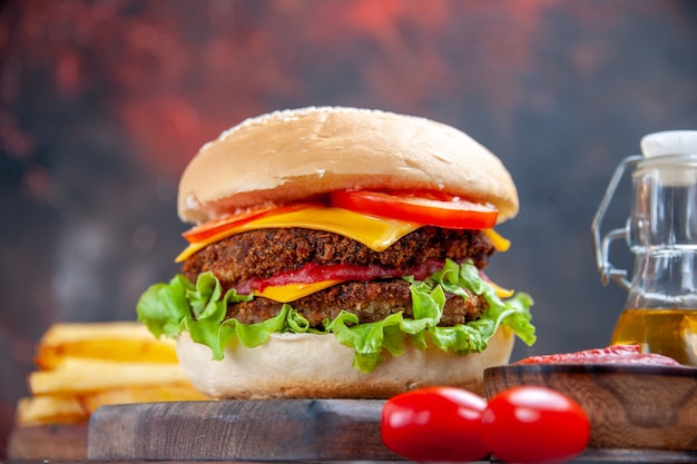 Front view tasty meat burger with french fries on dark background