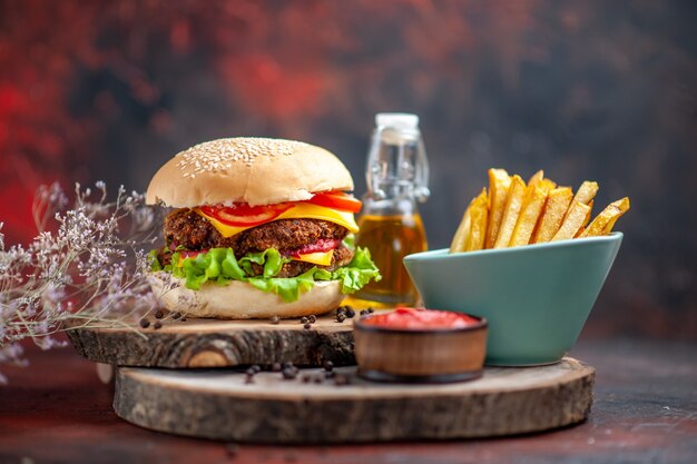 Front view tasty meat burger with french fries on the dark background