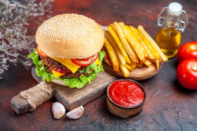 Free photo front view tasty meat burger with french fries on dark desk sandwich bun fast-food