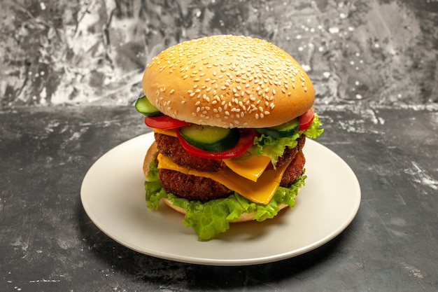 Front view tasty meat burger with vegetables on dark surface sandwich fast-food bun