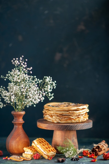 Front view tasty pancakes on dark-blue surface