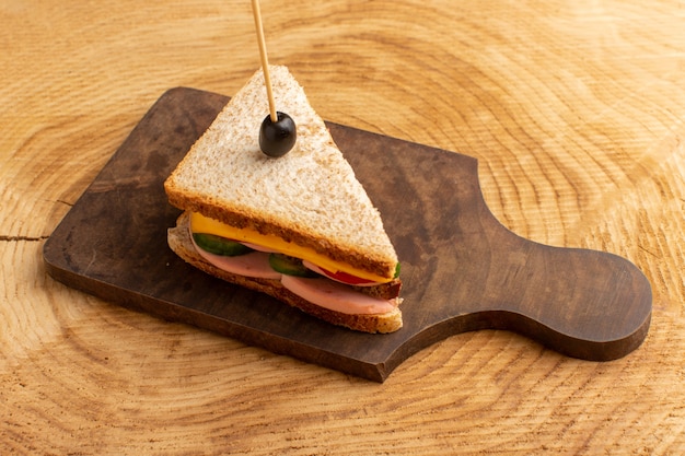 Free Photo front view tasty sandwich with olive ham tomatoes vegetables on wood