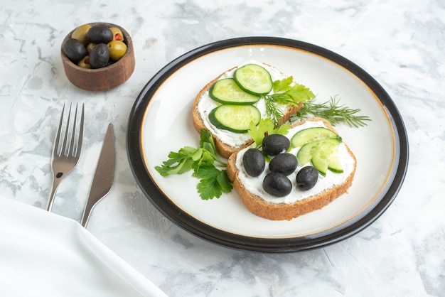 Front view tasty sandwiches with olives and cucumbers inside plate white background health toast meal burger food bread lunch horizontal