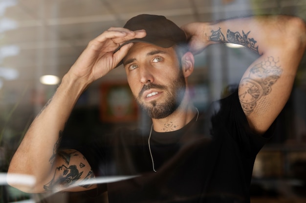 Front view tattoo artist wearing cap