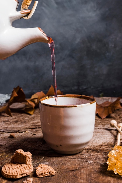 Front view tea being poured in cup