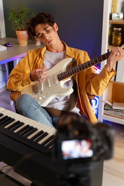 Front view teen playing the guitar