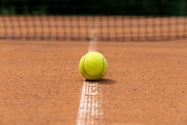 Front view tennis ball on court ground