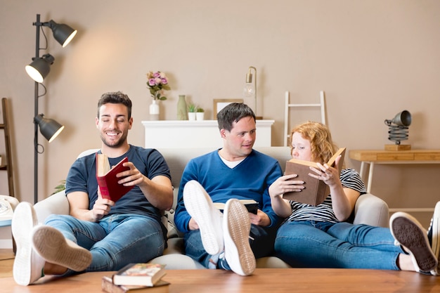 Front view of three friends holding books