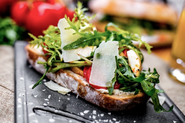 Front view toast with vegetables arugula and cheese on a tray