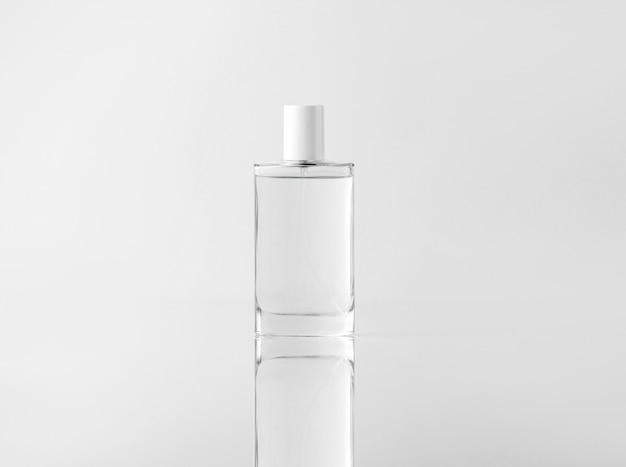 Free photo a front view transparent bottle for face cleaning procedures on the white wall